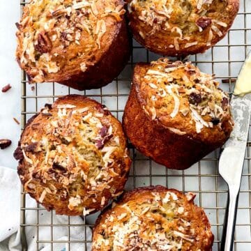 Banana Bread Muffins with Coconut and Pecans on cooling rack foodiecrush.com