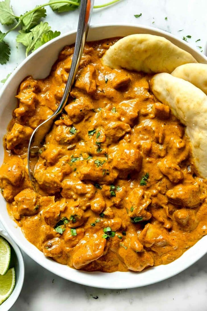 Indian Butter Chicken with naan in bowl foodiecrush.com