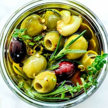 Marinated Olives Recipe with herbs in jar foodiecrush.com