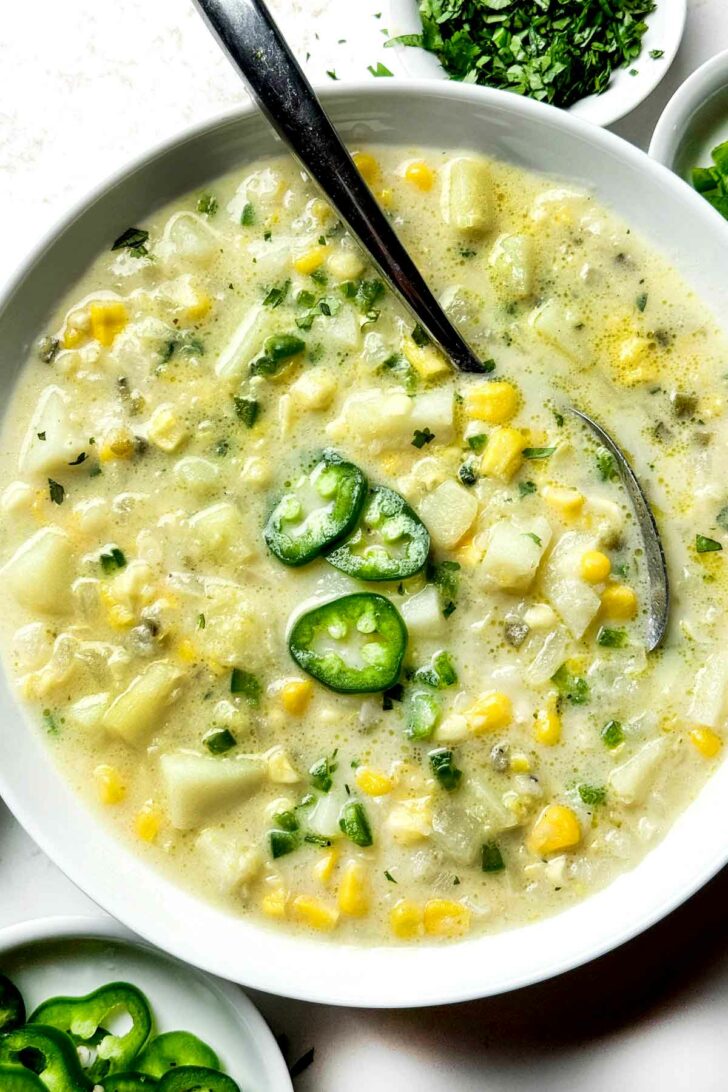 Potato Soup with Jalapeño and Corn in bowl with spoon foodiecrush.com